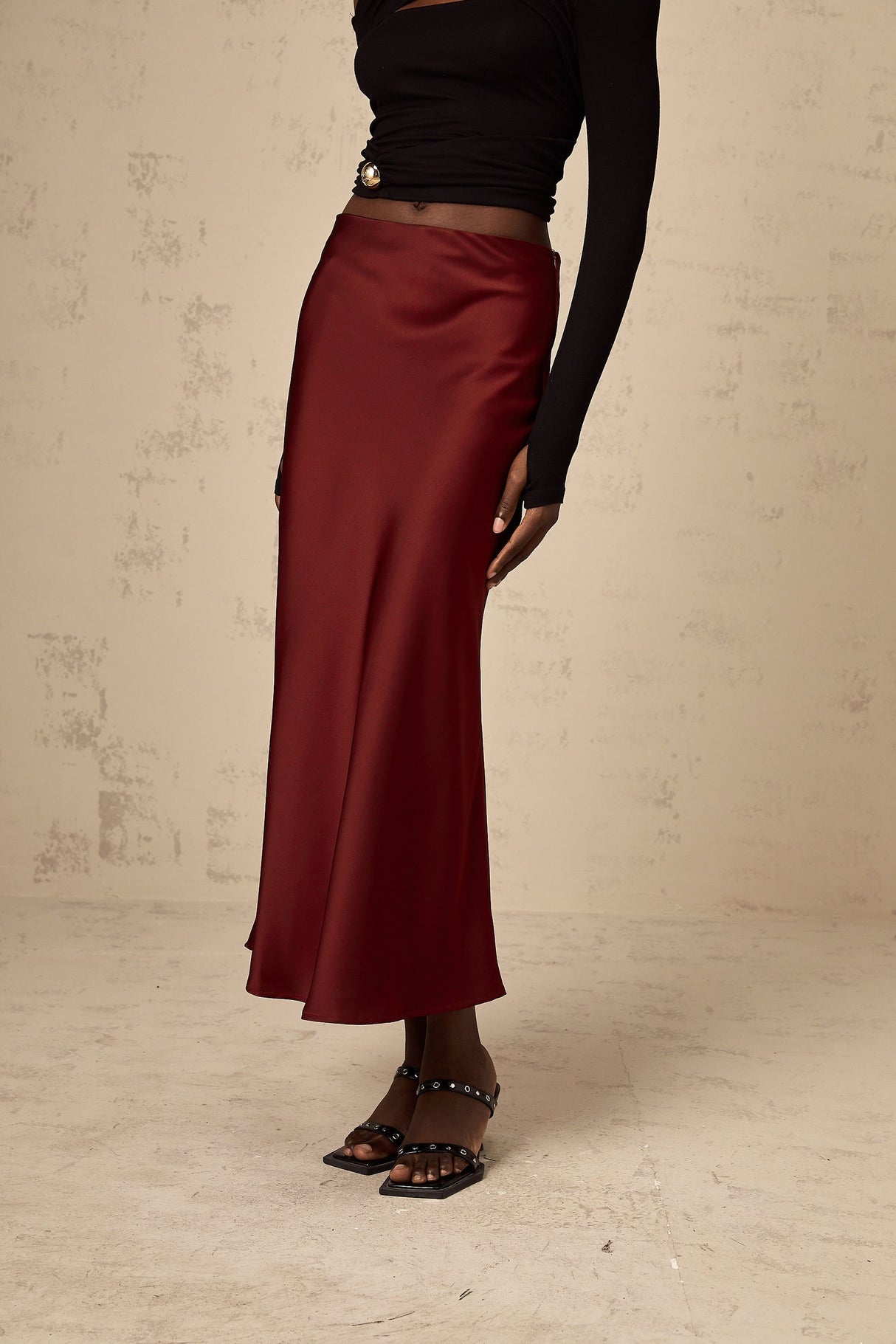 A red satin skirt with a flared silhouette named Vanessa