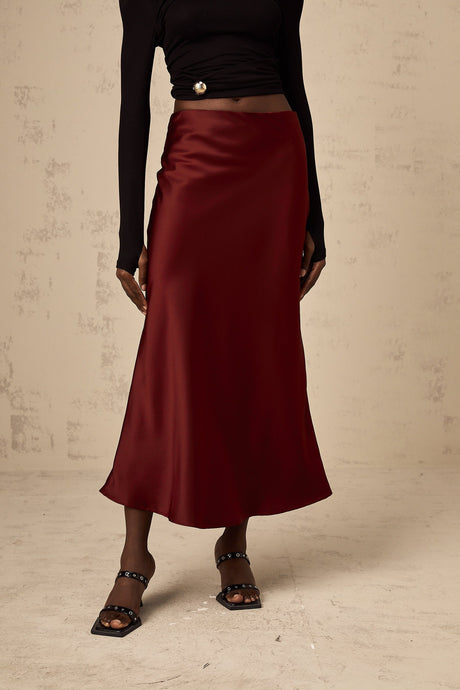 A red satin skirt with a flared silhouette named Vanessa