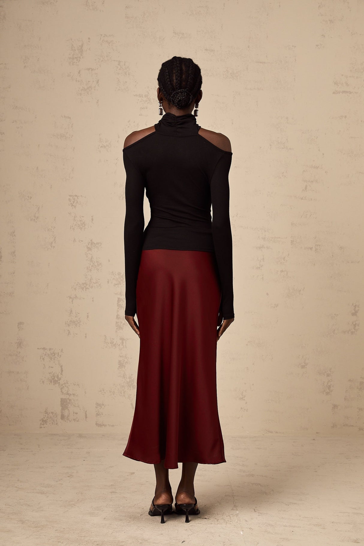 A red satin skirt with a flared silhouette named Vanessa