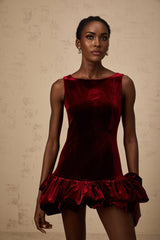 A red velvet mini dress with a peplum hem named Marion featuring a fitted silhouette and short length