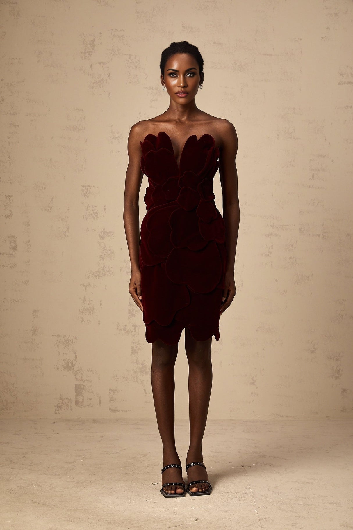 A red velvet mini dress with floral applique detailing by Maiwenn