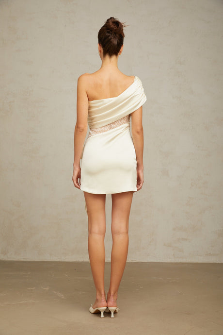 A short asymmetric dress in neutral tones featuring lace panels and a mini length