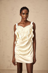 A short beige mini dress with butterfly patterns and draped fabric design featuring neutral tones and a flattering silhouette