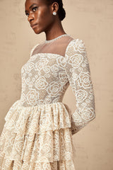 A short beige mini dress with delicate floral embroidery featuring a fitted bodice and flared skirt