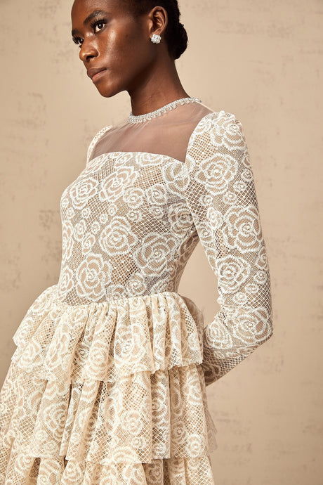 A short beige mini dress with delicate floral embroidery featuring a fitted bodice and flared skirt