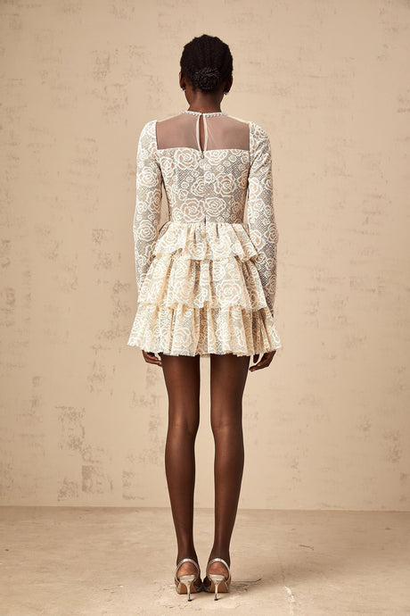 A short beige mini dress with delicate floral embroidery featuring a fitted bodice and flared skirt