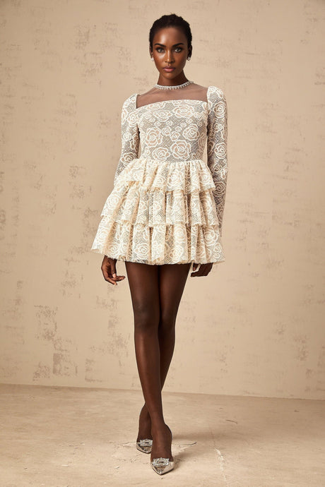 A short beige mini dress with delicate floral embroidery featuring a fitted waist and short sleeves