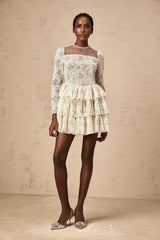 A short beige mini dress with floral embroidery details featuring a relaxed fit and delicate neutral tones