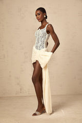 A short beige mini dress with floral lace pattern featuring a bowknot detail and pencil skirt silhouette