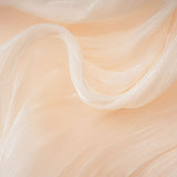 A short beige mini dress with full pleats and ruffles throughout featuring a flowy silhouette and feminine details