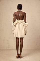 A short beige mini dress with ruffled details and delicate floral appliques in neutral tones