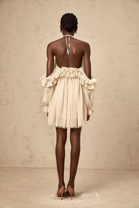 A short beige mini dress with ruffled details and delicate floral appliques in neutral tones