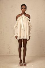 A short beige mini dress with ruffled details and delicate floral appliques scattered across the fabric