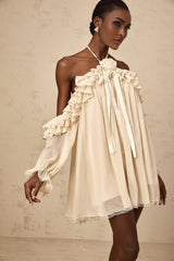 A short beige mini dress with ruffled layers and delicate floral applique details in neutral tones