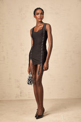 A short black bandage mini dress with hookandeye closures worn by a model standing against a plain background
