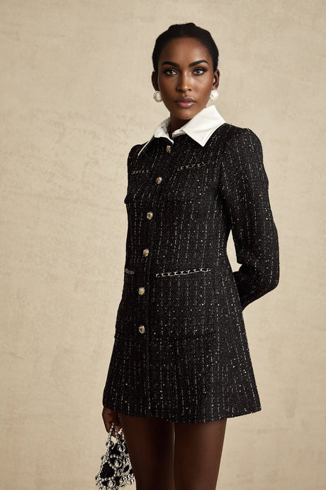 A short black dress with a tweed bodice and skirt featuring sequin panels creating a sparkly contrast against the textured fabric The dress has a mini length and likely showcases a classic Audrey Hepburn inspired silhouette