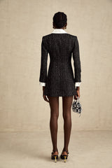 A short black dress with a tweed fabric base and sequin panels combining classic and glamorous elements in a mini length style named Audrey