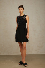 A short black mini dress adorned with sequins featuring a butterfly design pattern