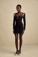 A short black mini dress with a bustier top covered in shiny sequins