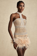 A short black mini dress with crystal embellishments and feather trim along the hem and neckline