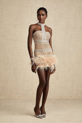 A short black mini dress with crystal embellishments and feather trim around the hem and neckline elegant cocktail attire with luxurious details