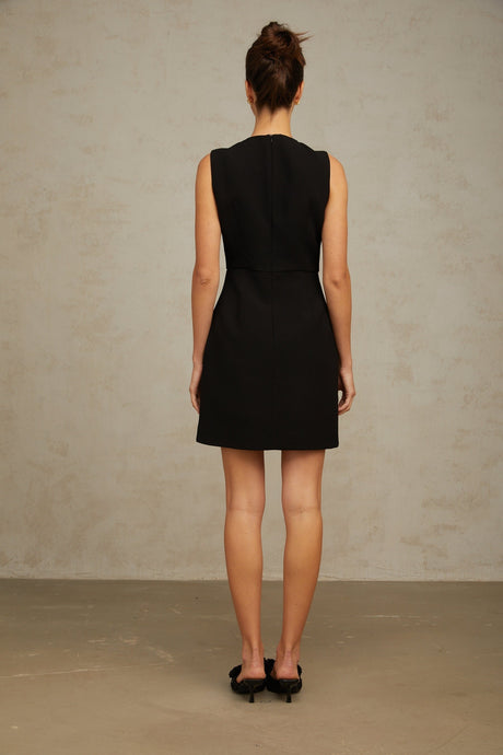 A short black mini dress with sequin embellishments featuring a butterfly design