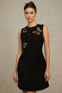 A short black mini dress with sequin embellishments in a butterfly pattern