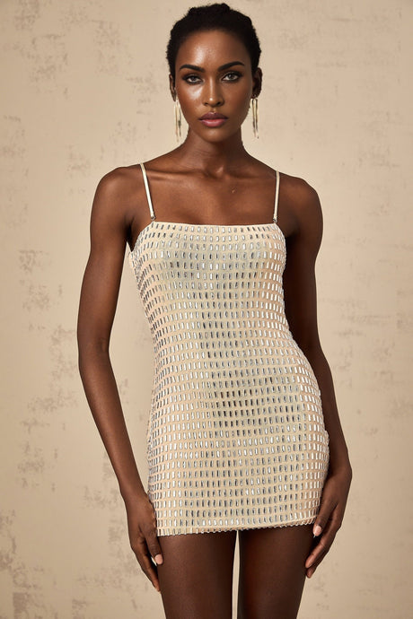 A short black mini dress with silver stud embellishments covering the fabric creating a shimmering effect The dress has a sleeveless design and a form fitting silhouette
