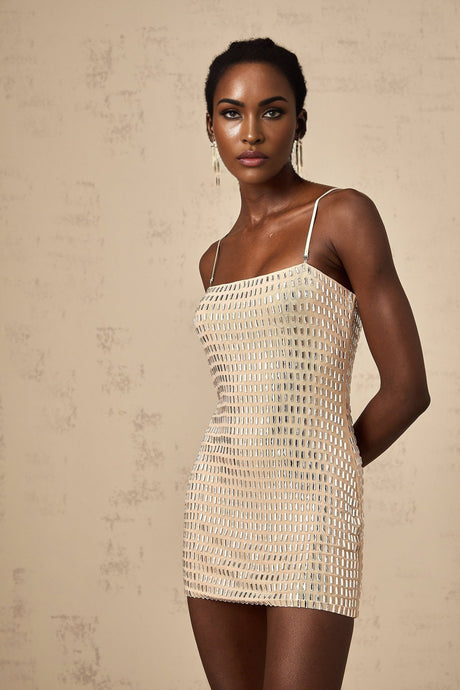 A short black mini dress with stud embellishments adorning the fabric creating a stylish and edgy look