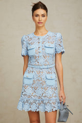 A short blue lace mini dress with ruffled details and floral applique decorations