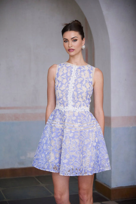 A short blue mini dress with crochet lace detailing and puff sleeves