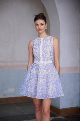 A short blue mini dress with crochet lace details and puff sleeves