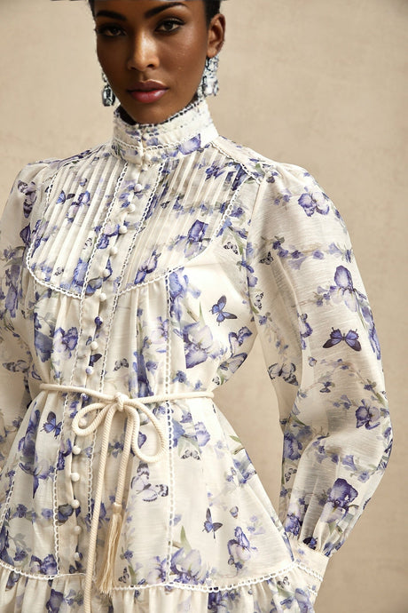 A short chiffon mini dress with a flared skirt featuring a colorful floral print pattern named Blandine