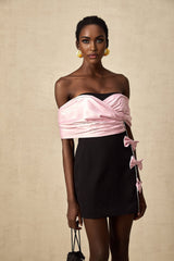 A short colorblocked mini dress with a bow embellishment featuring contrasting colors and a feminine silhouette