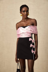 A short colorblocked mini dress with a bow embellishment featuring the name Doria