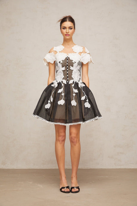 A short colorblocked mini dress with floral embroidery details featuring a mix of contrasting colors and a feminine silhouette
