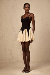 A short dress with a colorblocked design featuring godet pleats and a mini length called the Justine dress