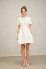 A short dress with a floral applique design featuring Adrienne style in a mini length