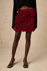 A short flared mini skirt with three dimensional petal like details creating a textured A line silhouette