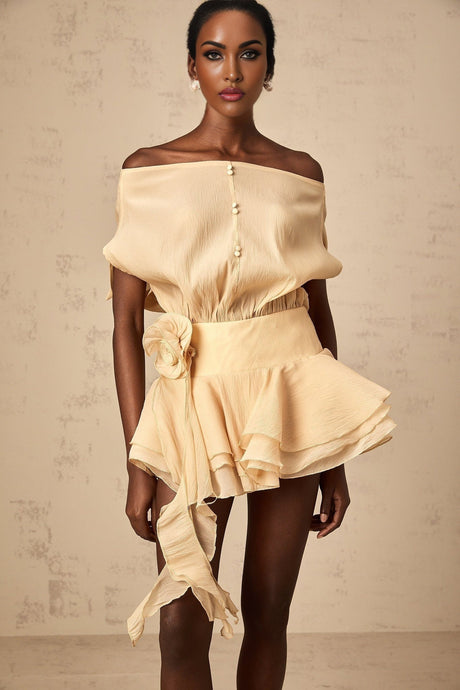 A short floral dress with ruffled hem and floral applique details in a feminine style reminiscent of the movie Amelie