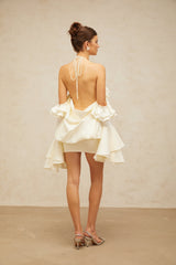 A short floral dress with ruffles and cold shoulder design featuring a floral pattern and mini length