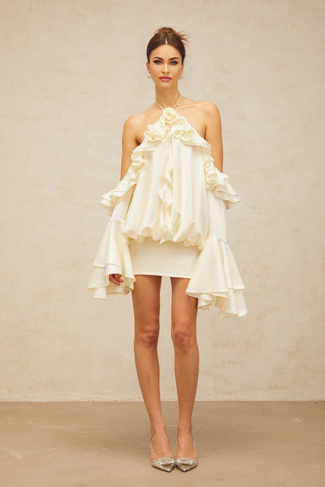 A short floral dress with ruffles and cold shoulder design featuring a vibrant floral pattern on a light background