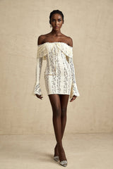 A short floral lace mini dress in neutral tones with flared cuffs named Émeline