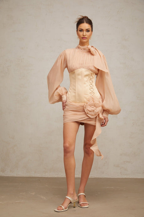 A short floral mini dress with cinched waist and floral applique panels featuring a mix of colors and textures