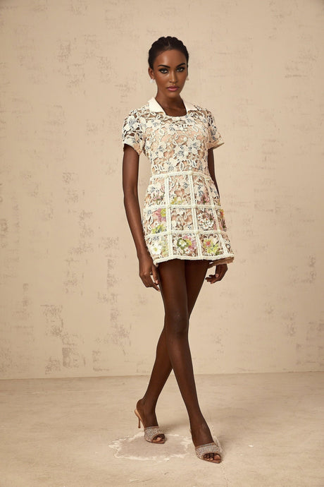 A short floral mini dress with embroidered flower details and a feminine silhouette