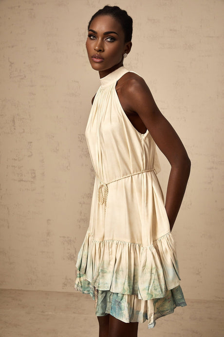 A short floral mini dress with multiple layers featuring a mixed pattern print design in light colors