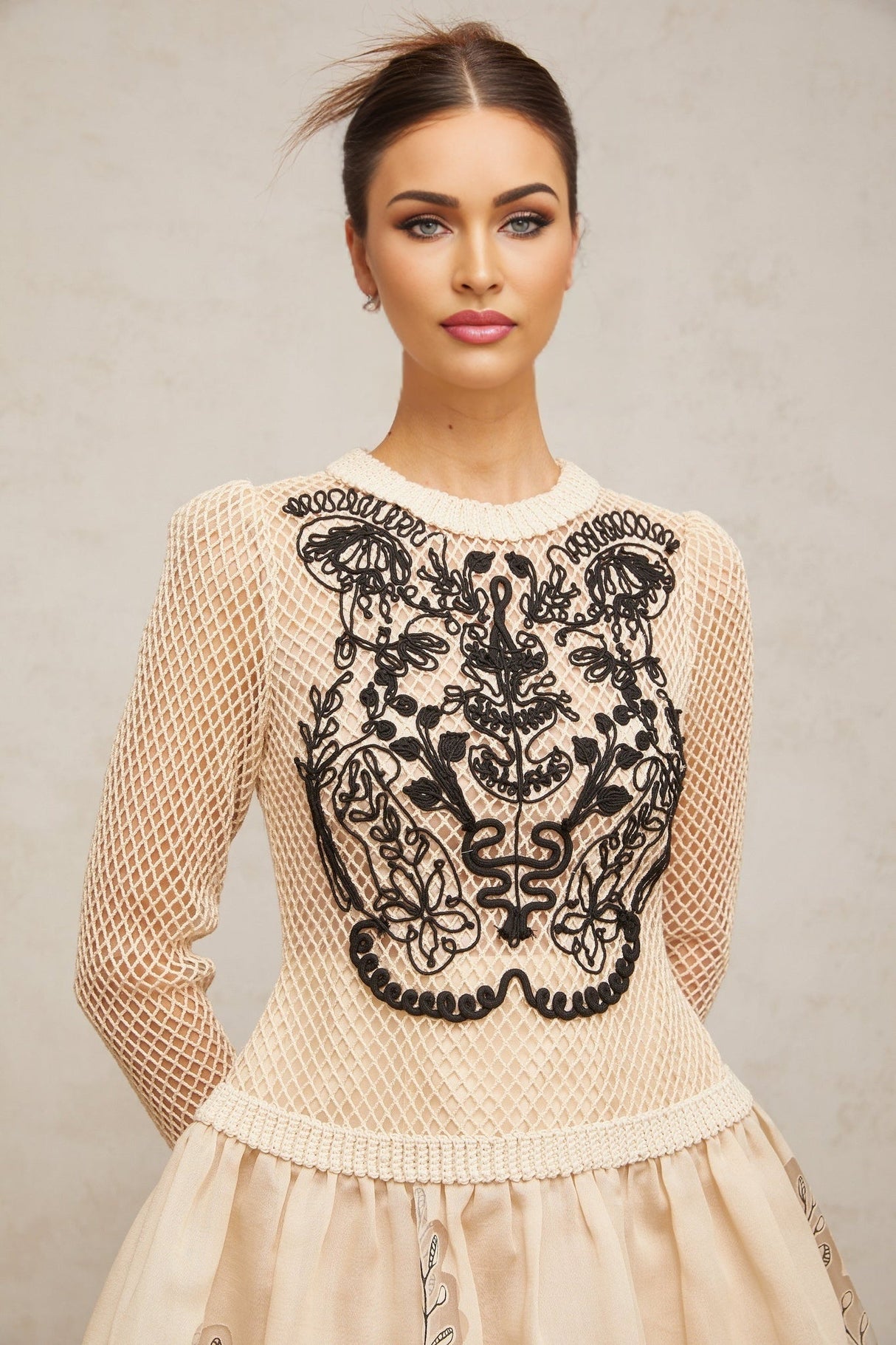 A short floral patterned mini dress with contrasting color applique details and jacquard fabric featuring a floral design