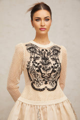 A short floral patterned mini dress with contrasting color applique details and jacquard fabric featuring a floral design