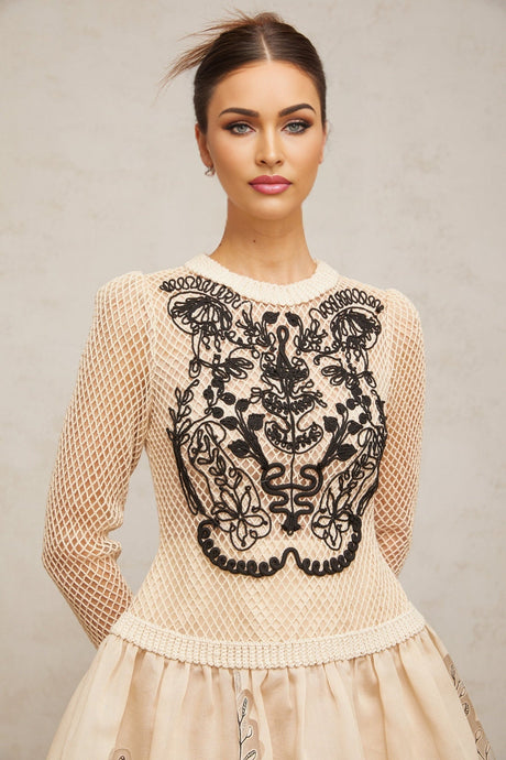 A short floral patterned mini dress with contrasting color applique details and jacquard fabric featuring a floral design