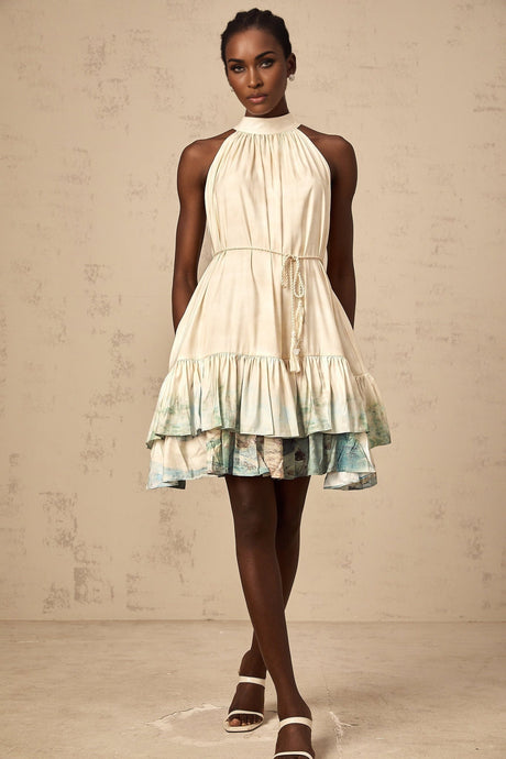 A short floral patterned mini dress with multiple layered tiers and a vibrant colorful print creating a flowy silhouette